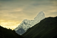 Ama Dablam - by far one of the most beautiful mountains of the Great Himalayas of Eastern Nepal. The main peak is 6,812 metres (22,349 ft), the lower western peak is 5,563 metres (18,251 ft). Ama Dablam means "Mother's Necklace"; the long ridges on each side like the arms of a mother (ama) protecting her child, and the hanging glacier thought of as the dablam, the traditional double-pendant containing pictures of the gods, worn by Sherpa women. For several days, Ama Dablam dominates the eastern sky for anyone trekking to Mount Everest basecamp.